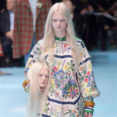 gucci models held replicas of heads